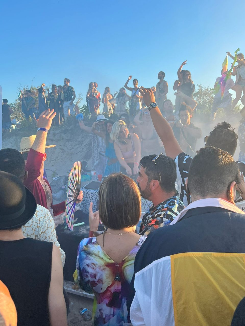 The Deep Playa crowd dancing on the beach in morning haze