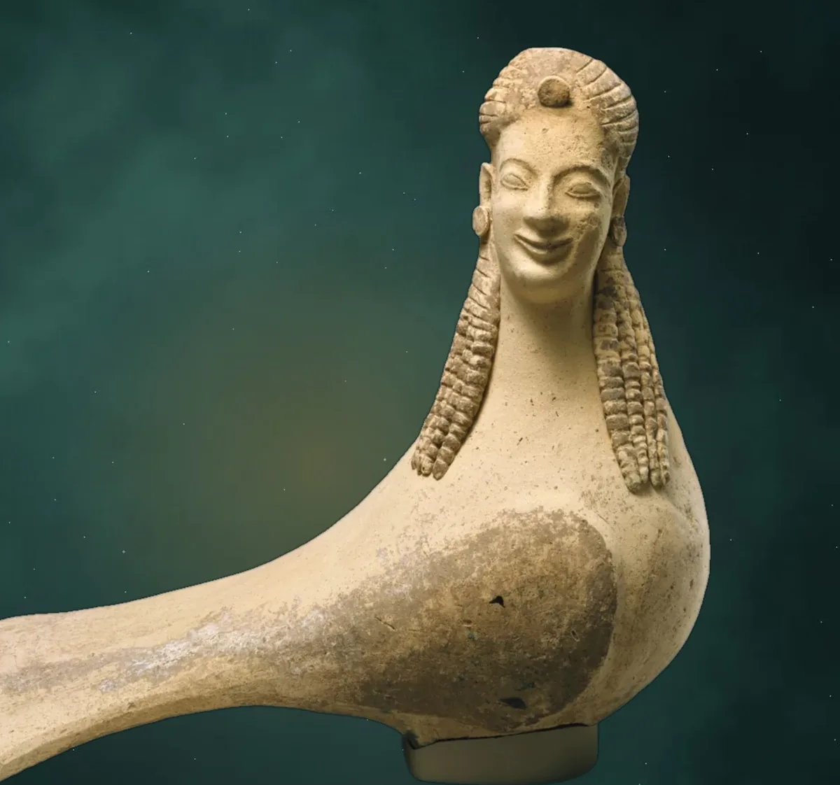 A Greek terracotta siren: a bird's body with a smiling woman's face and long braided hair