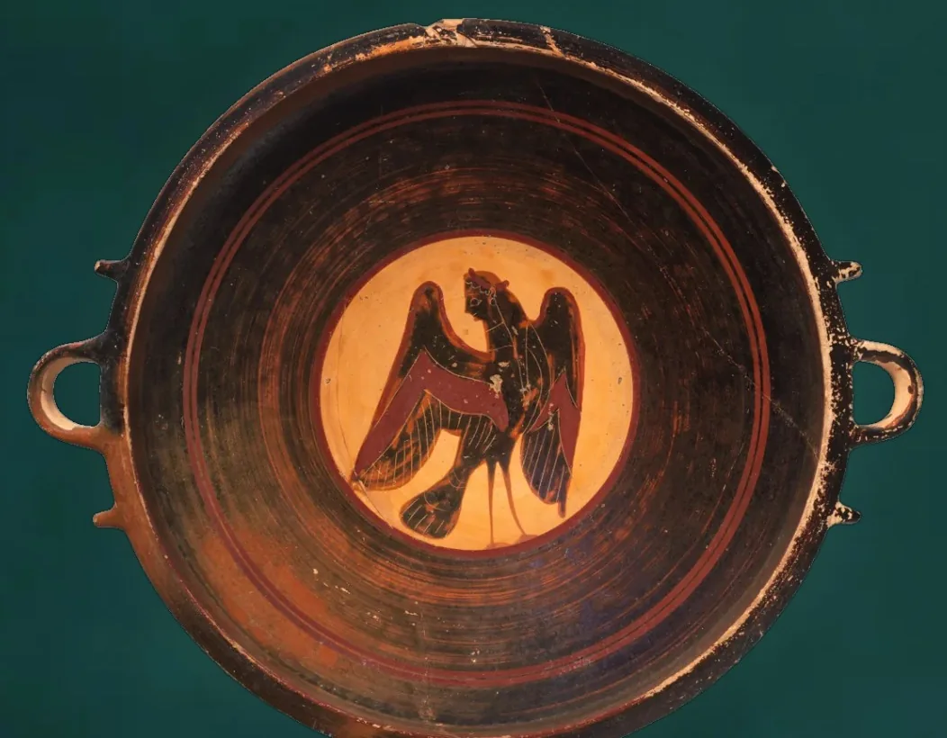 A painted bowl with a winged siren in the center